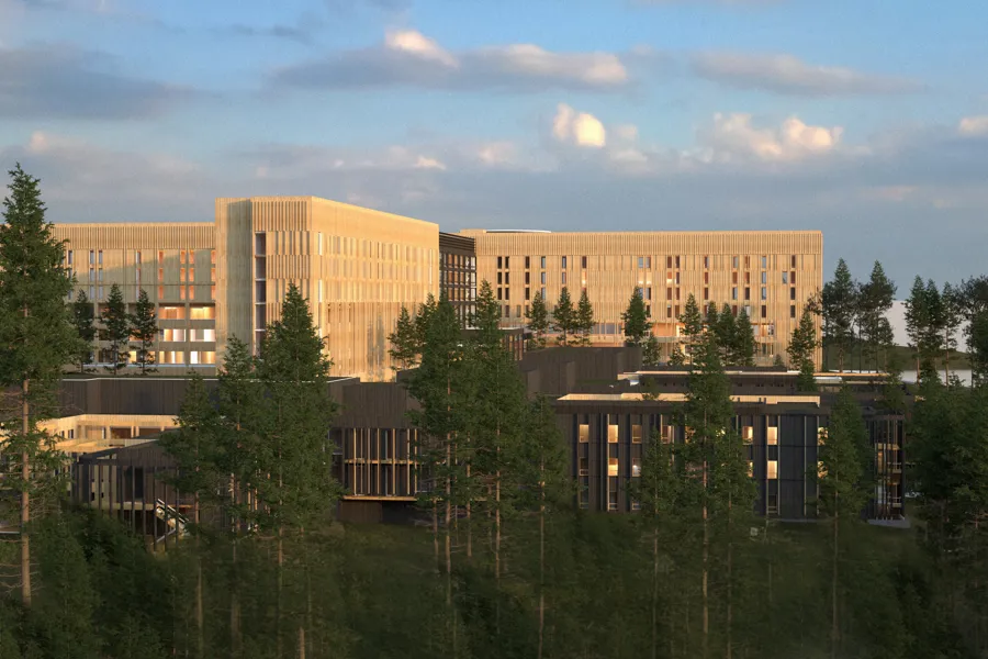 En stor bygning med trær foran seg