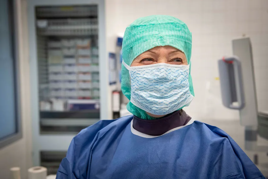 Personell med munnbind og smittevernfrakk