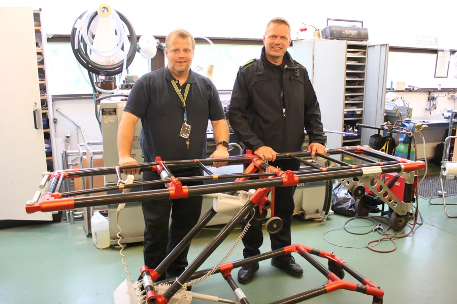 Menn som står ved siden av en maskin