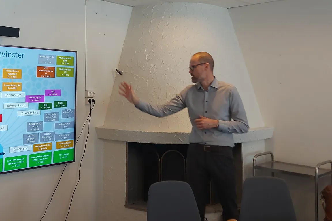 En person som står foran en skjerm med en presentasjon