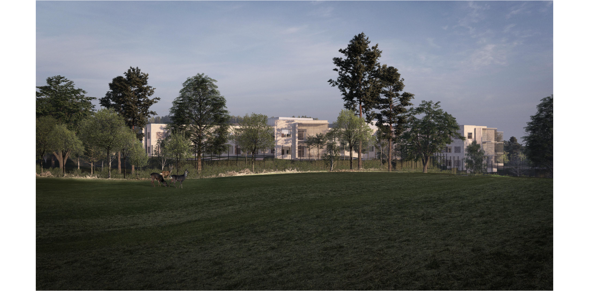 A large green field with trees and buildings in the background