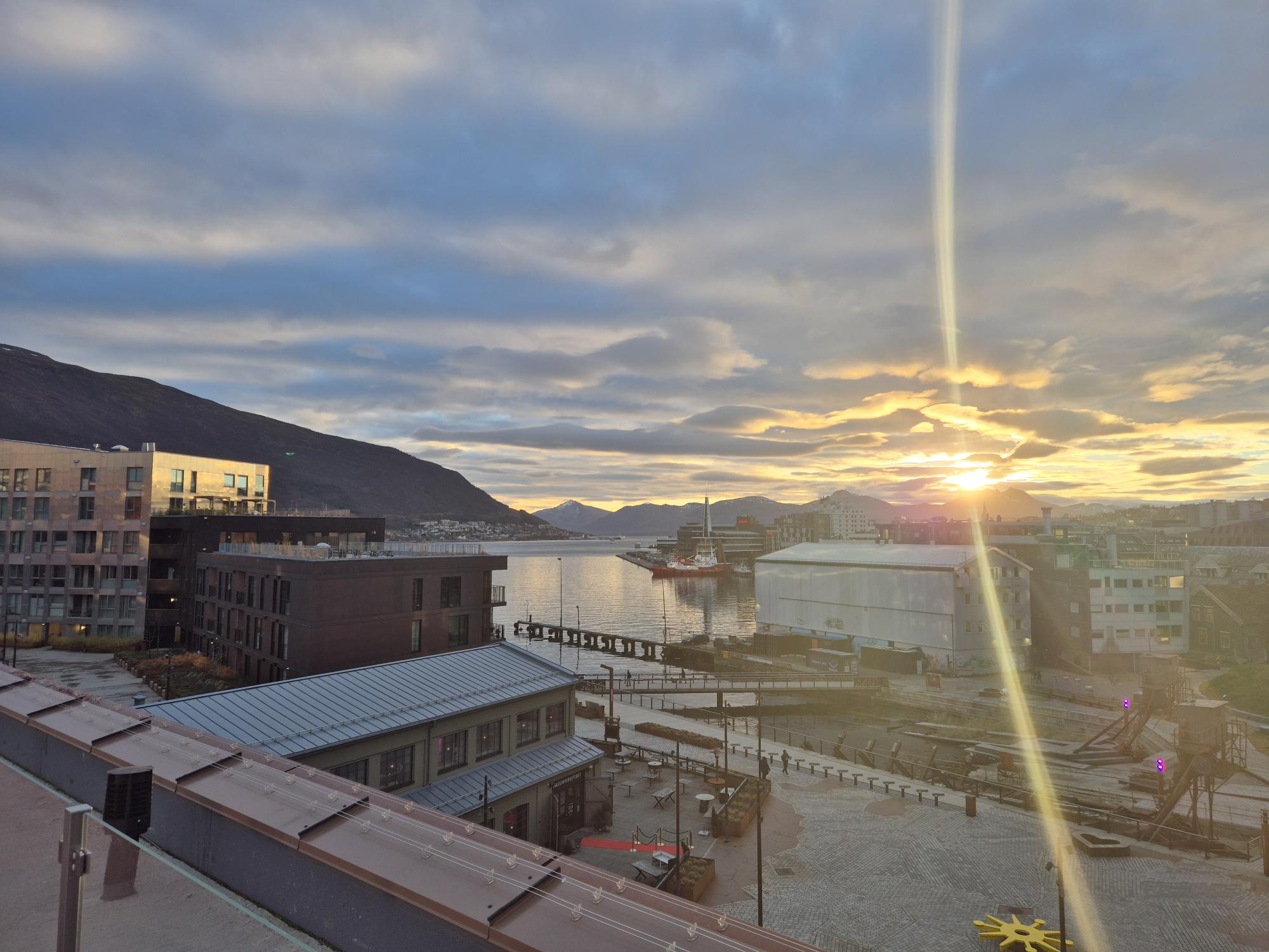 En by med bygninger og en solnedgang