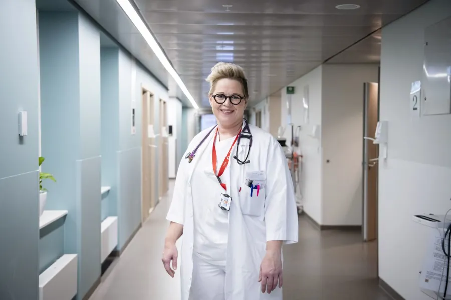 En mann iført hvit frakk og stetoskop